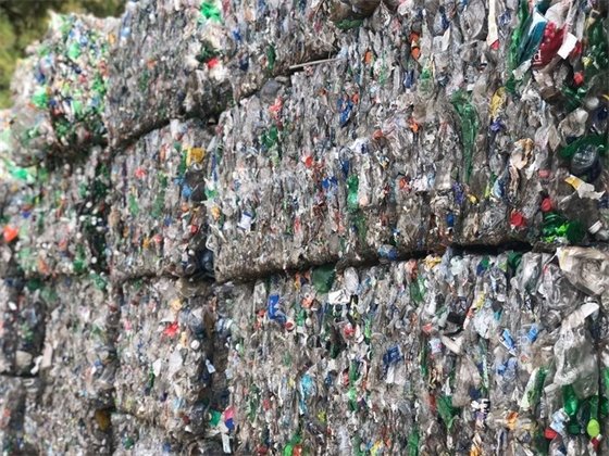 Image of recycled plastic bottles packed tightly and ready to be shipped. 